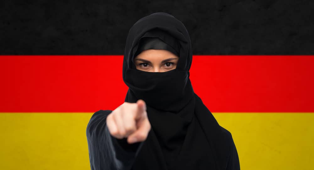 immigration,and,people,concept, ,muslim,woman,in,hijab,pointing